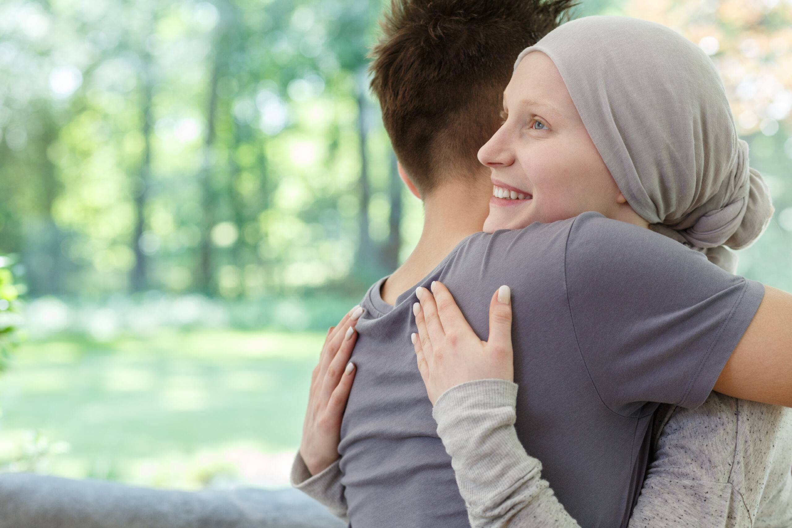 young couple hugging in forest