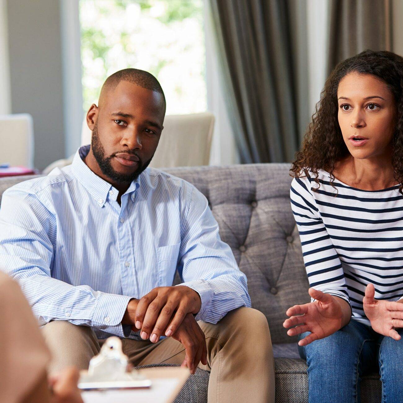 a married couple sitting down in an office interviewing a registered clinical counsellor to see if she is the right fit